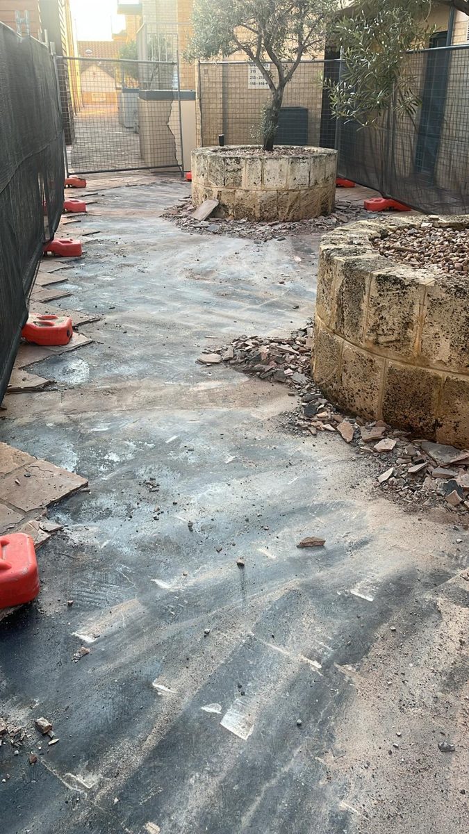 Deteriorated walkway and exposed concrete before remediation at Hillarys strata complex