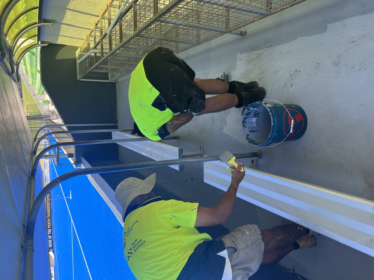 Close-up detail of membrane and anti-slip coating application on grandstand steps